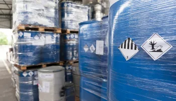 Waste barrels with hazard warning symbols in the warehouse