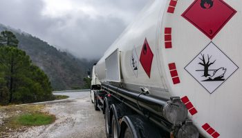 Fuel tank truck with its plates and danger labels on the road